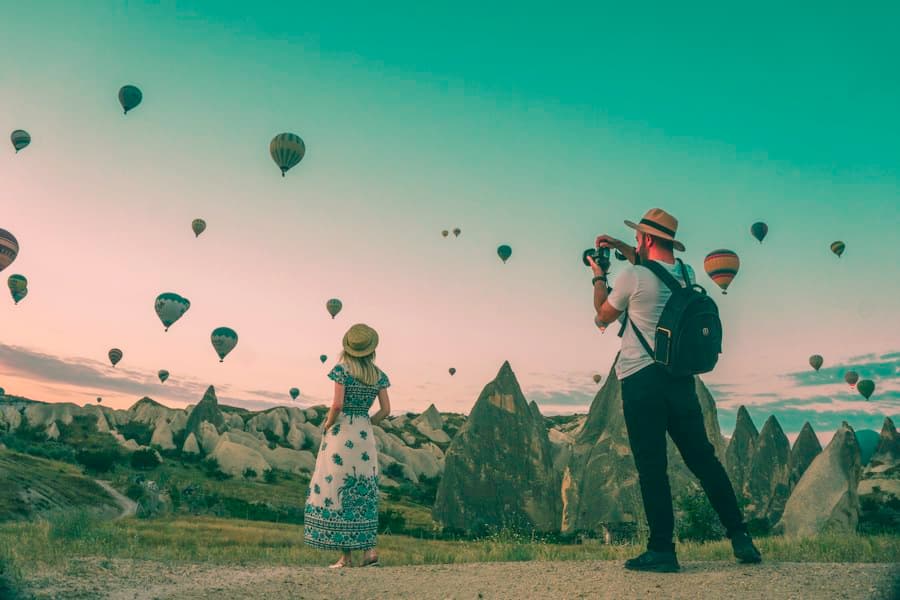 Travelers taking in a mountain landscape